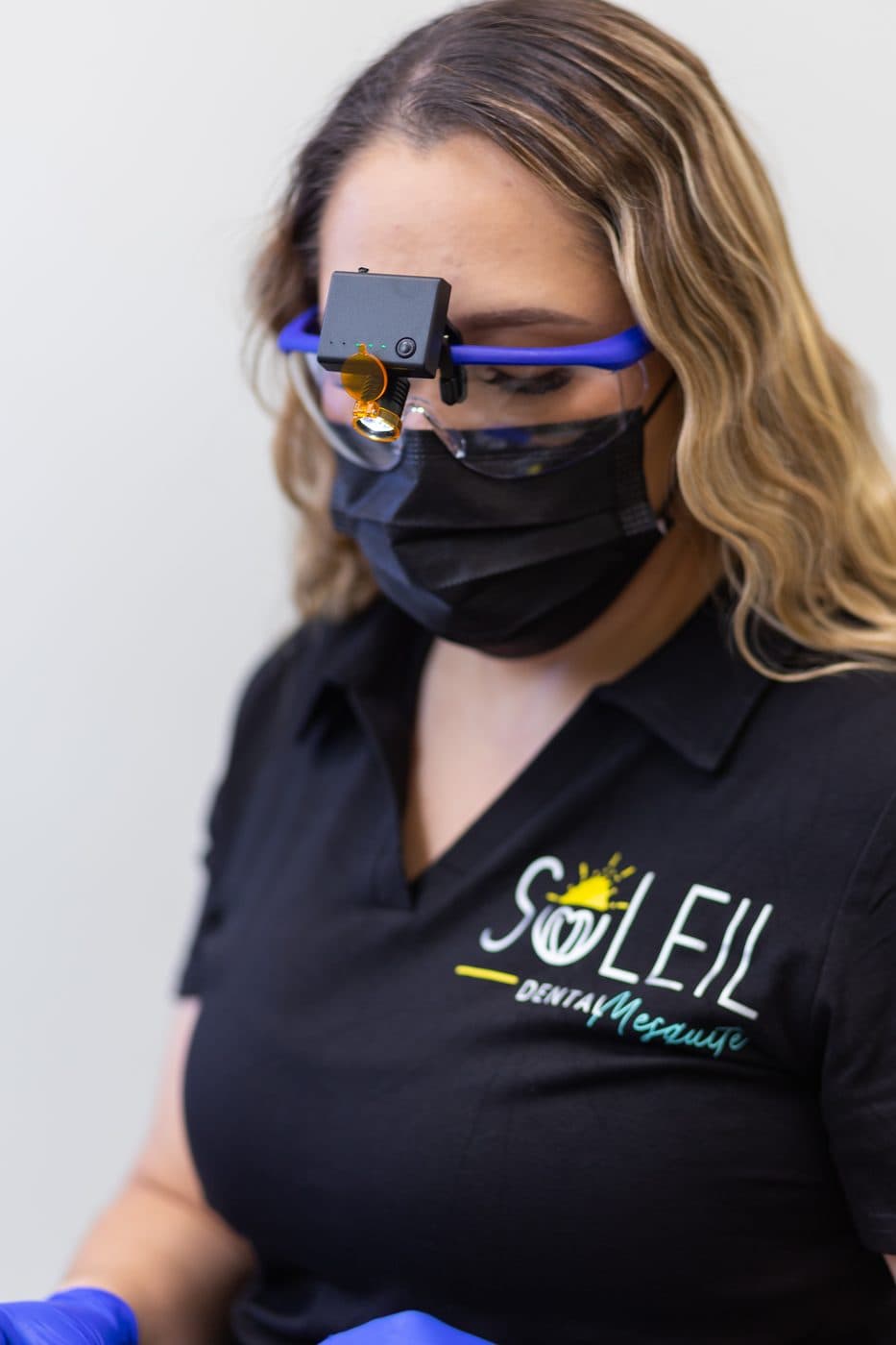 A Soleil Dental Mesquite team member in loupes and a mask, ready for a cleaning
